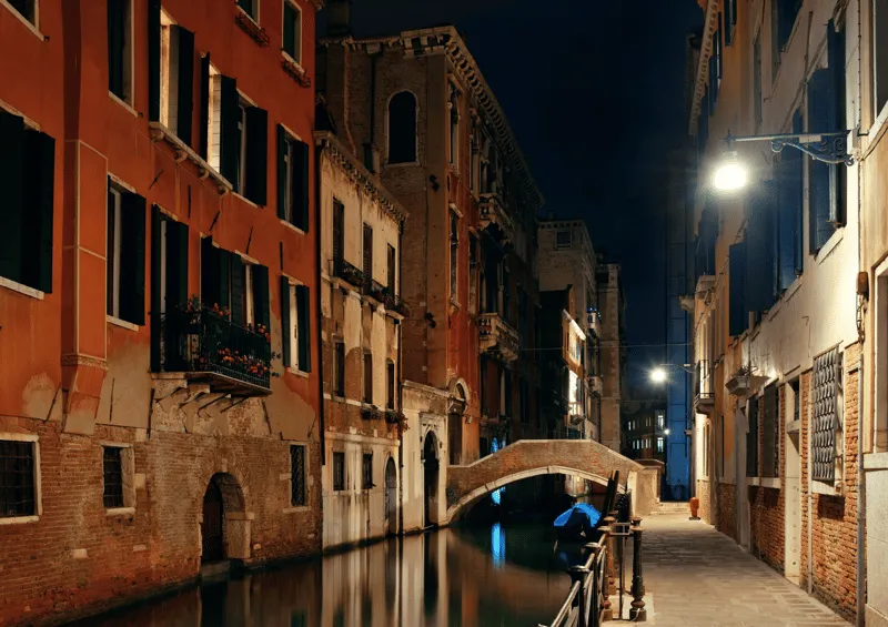 Venice canal reflecting Gothic palace facades at golden hour during a crimes legends and mysteries sunset walking tour in Venice Italy
